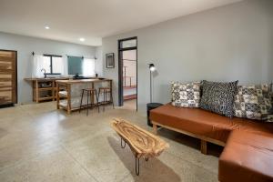 a living room with a couch and a table at The Drift Cottage in Livingstone