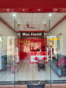 a store front with a sign for an hotel at Om Hotel & Lodge in Baharāgora