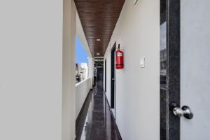 a hallway of a house with a fire hydrant hanging from the ceiling at Super Collection O Kachiguda Bus Terminal Hyderabad in Vidya Nagar