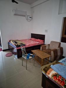 a living room with a table and a couch at Om Hotel & Lodge in Baharāgora