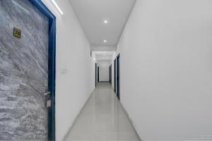 a corridor in a building with white walls and a long hallway at Collection O Saral Bihari Temple Formerly Black Panther in Sheodāspura