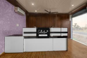 a room with white cabinets and a sign on the wall at Collection O Saral Bihari Temple Formerly Black Panther in Sheodāspura
