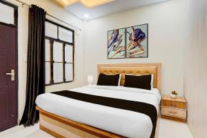 a bedroom with a large bed and a window at OYO Hotel O Subedarganj Railway Junction Formerly Krishna Inn in Prayagraj +40 photos