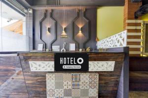a hotel counter with a sign on the wall at OYO Hotel O Subedarganj Railway Junction Formerly Krishna Inn in Prayagraj