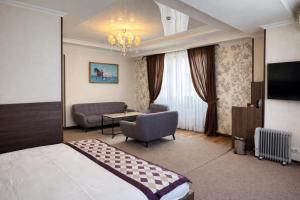 a hotel room with a bed and a couch at Bishkek Centrum Hotel in Bishkek +46 photos