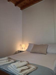 a bedroom with a bed with towels on it at Divine Island Escape in Kini