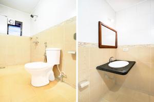 a bathroom with a toilet and a sink at Super Collection O Holiday Street Calangute Formerly Shruti Resort in Goa