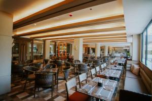 a restaurant with tables and chairs in a building at Coron Westown Resort Premier in Sampong