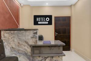 an office with a desk and a hotel sign on the wall at Hotel O Deva Road Lucknow Formerly Awadh Regency in Lucknow