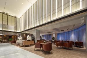 a rendering of a restaurant with tables and chairs at Wyndham Shanghai Pudong in Shanghai