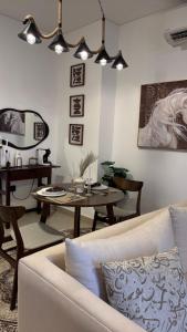 a living room with a couch and a table at Alaziba view in ‘Udhaybah
