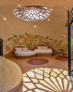 a room with three beds and a chandelier at Eleve in Assagao +19 photos
