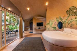 a bedroom with a large bed in a room at Eleve in Assagao