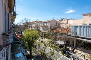 an apartment balcony with a view of a garden at Dimora - A Spacious Luxury Penthouse in Town's Heart in Corfu