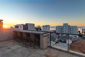 a bar on a rooftop with a view of the city at Namaste in Cape Town