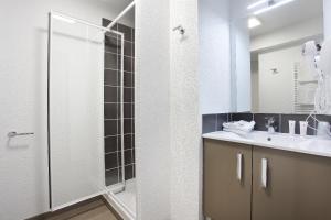 a bathroom with a shower and a sink at Appart Hotel Odalys City Marseille Le Dôme in Marseille
