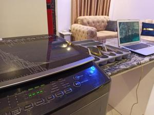 a kitchen with a stove and a laptop on a counter at Delight 1 Bedroom Apartment - Off Awolowo Road Ikeja in Ikeja +4 photos