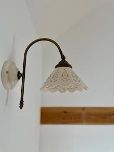 a lamp hanging on a wall next to a wall at Domek w Jacni in Jacnia