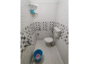 a bathroom with a toilet and a sink at Srt rajput hotel Subhash Marg Charbhag Lucknow in Lucknow +5 photos