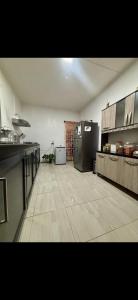 a large room with a kitchen with a refrigerator at Perle rare Lodge in Diamond Island