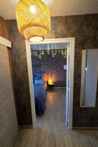 a bedroom with a bed and a large chandelier at L atelier des jeux in Beauvais