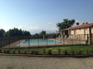 a swimming pool in front of a house at Villa Gourmet in Orentano