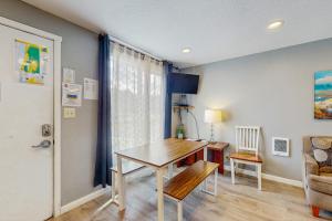 a dining room with a table and a chair at Sea Treasures Inn #114 in Rockaway Beach