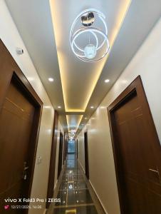 a hallway in a building with a ceiling with a chandelier at Hotel Akshansh Inn in Agra