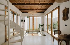 a living room with a staircase and a couch at Palm Valley Loft in Kuta Lombok