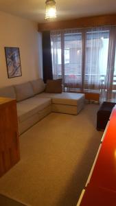 a living room with a couch and a large window at Thyon 2000, Vex, Les Collons, studio Velan 218 in Vex