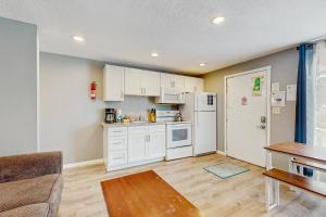 a kitchen with white cabinets and a table at Sea Treasures Inn #114 in Rockaway Beach