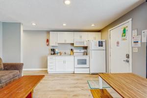 a kitchen with white cabinets and a white refrigerator at Sea Treasures Inn #114 in Rockaway Beach +13 photos