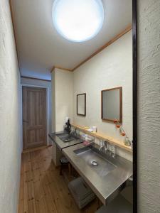 a bathroom with two sinks and a large mirror at 嬉々の屋KIKI Chalet in Hakuba +75 photos