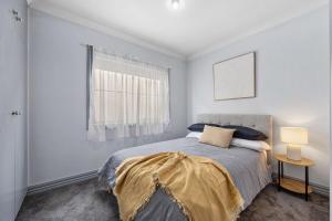 a bedroom with a bed and a window at The Laneway - 3BR, Pet Friendly, Walk to CBD in Port Lincoln