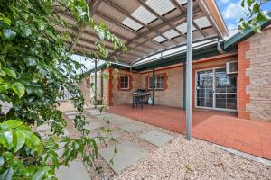 an outdoor patio with a brick building with a roof at The Laneway - 3BR, Pet Friendly, Walk to CBD in Port Lincoln