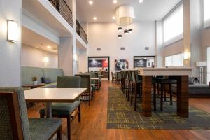 a dining room with tables and chairs and a cafeteria at Hampton Inn & Suites College Station in College Station
