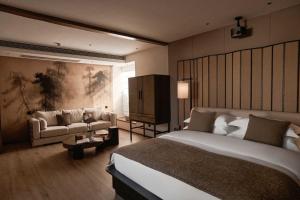 a hotel room with a bed and a couch at Hotel NANDANA in Diannan +145 photos