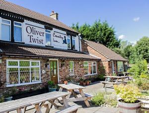 a couple of picnic tables in front of a building at Oliver Twist Country Inn in Wisbech