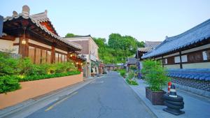 an empty street in an asian town with buildings at Hanok Onew in Jeonju