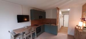 a kitchen with a table and a counter top at Vallonpierre2 in Orcières