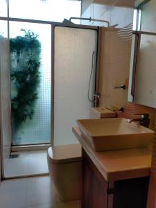 a bathroom with a sink and a toilet and a window at Dilvilla in Nikawatawana