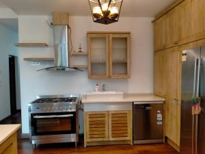 a kitchen with a stainless steel stove and a sink at Dilvilla in Nikawatawana