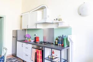 a kitchen with a stove and a refrigerator at Principi di Piemonte Apartments in Tirrenia