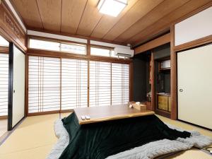 a room with a table and a large window at わのおうち善 in Nitanzawa +38 photos