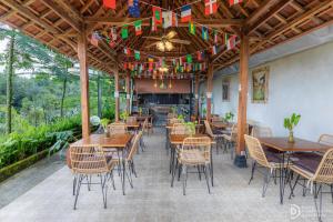 a restaurant with wooden tables and chairs and flags at The Hidden Valley in Besakih
