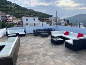 a patio with couches and tables on a roof at B&B Ágora in Sayalonga