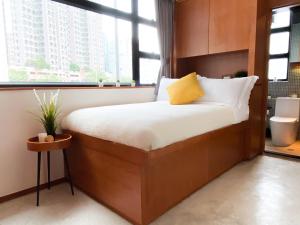 a bed in a room with a large window at Oootopia Tai Kok Tsui in Hong Kong +4 photos