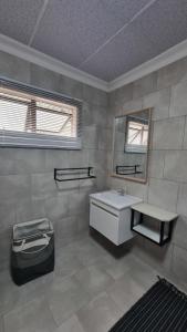a bathroom with a sink and a mirror at Maggie's Farm Stay in Khanzi +37 photos