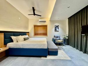 a bedroom with a large bed with a blue headboard at Kaysons hotel in Hyderabad +8 photos