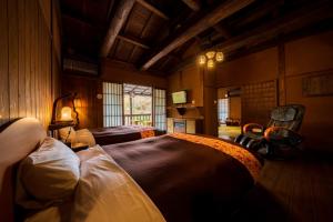 a room with two beds and a tv in it at Hozantei in Minamioguni